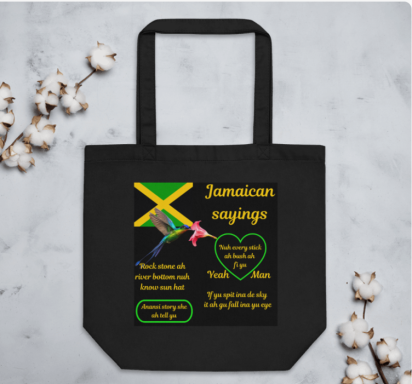 Black tote bag featuring Jamaican sayings and motifs, with a colourful background.