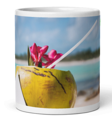 A coconut cup with pink flowers on a beach background.